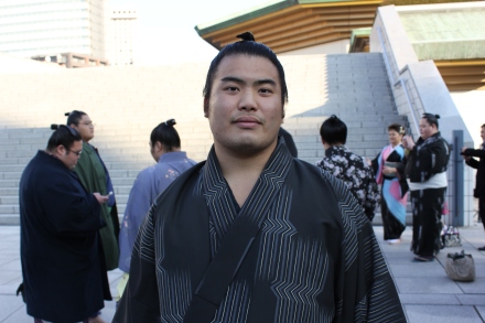 It was completely worth standing up on a fence and being laughed at by bystanders to take this wrestler's portrait... I especially love the other sumo wrestlers on their cell phones; that would be the classic, oft-observed ancient clashing with modern here in Japan! 