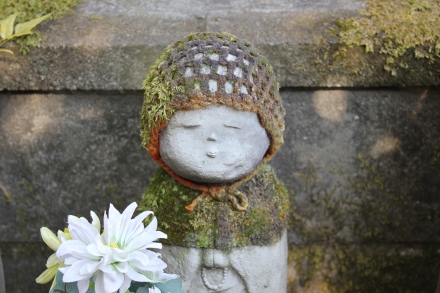Some of the statues' bonnets and bibs were brand new, and some - like this one - seemed to have been on long enough to take on characteristics of the garden's natural environment. 